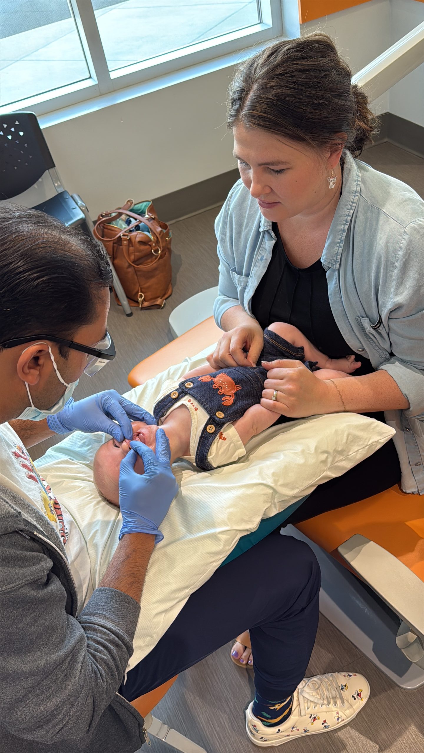 Child receiving a lip tie evaluation from a pediatric dentist