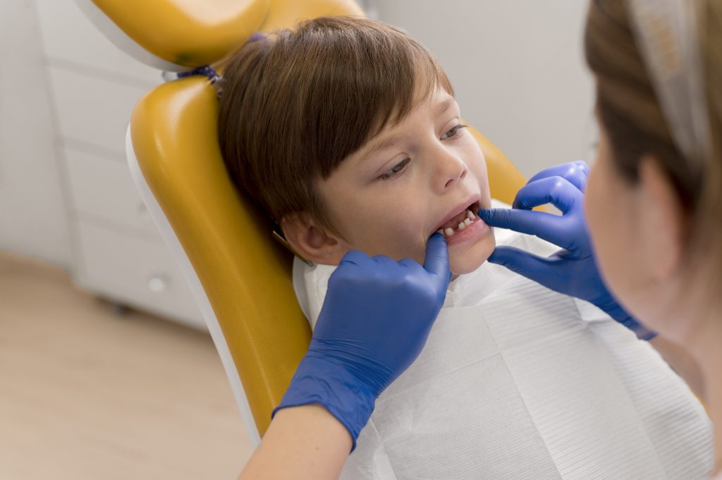 Child receiving a lip tie evaluation from a pediatric dentist