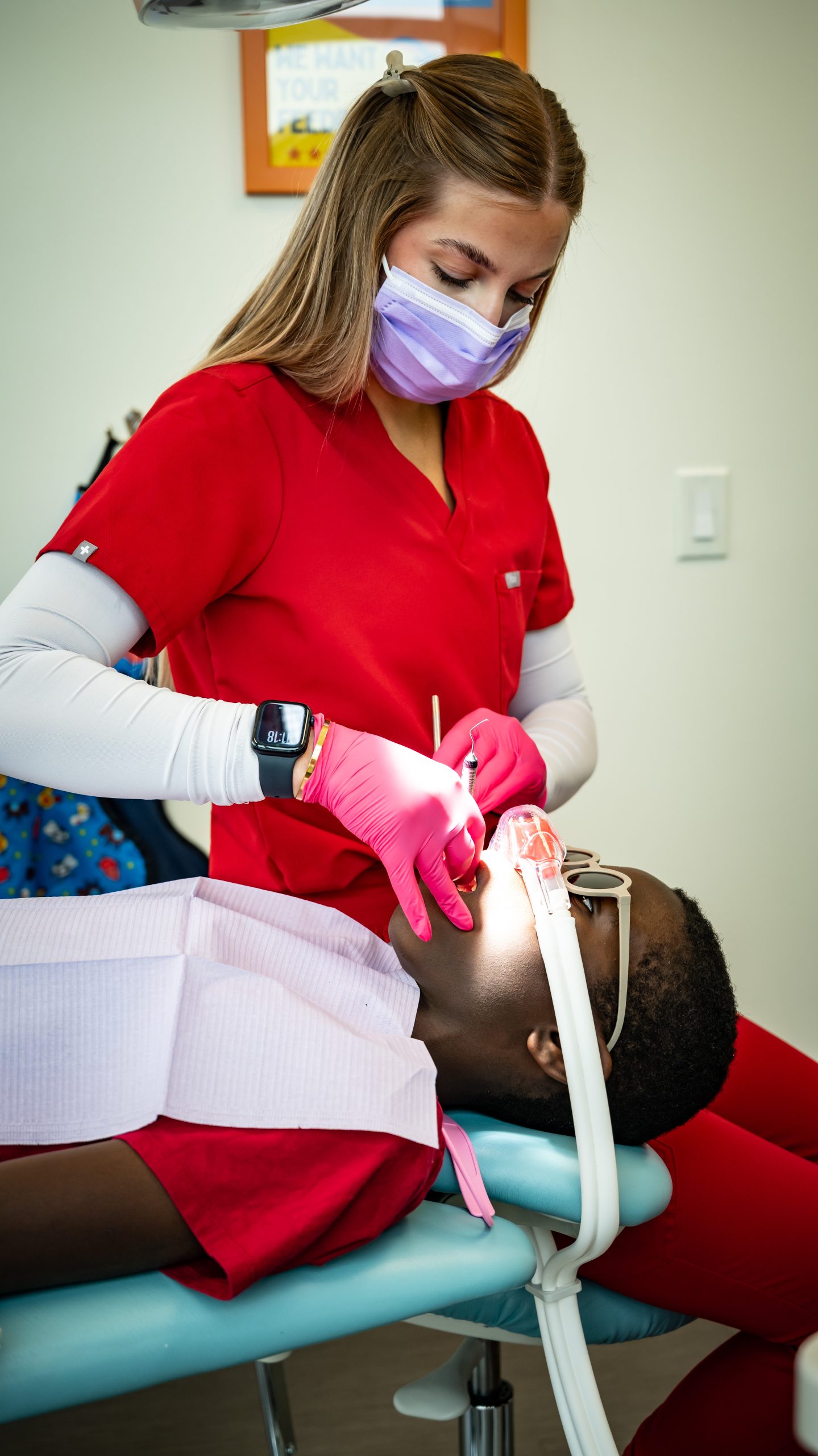 Child receiving sedation dentistry during a pediatric dental treatment