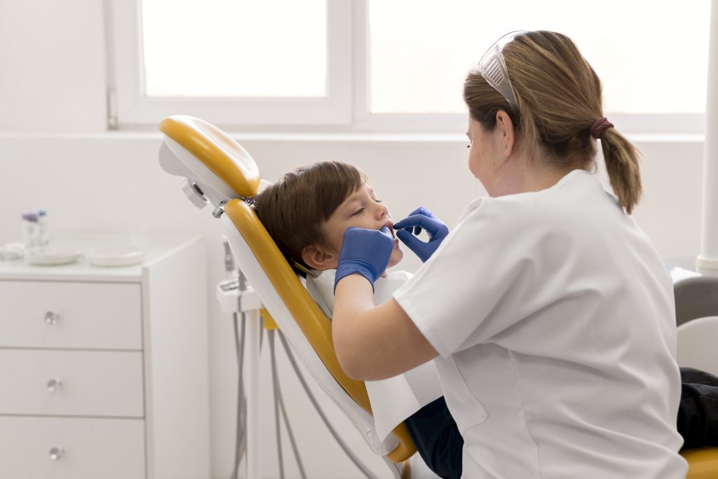 Child receiving sedation dentistry during a pediatric dental treatment